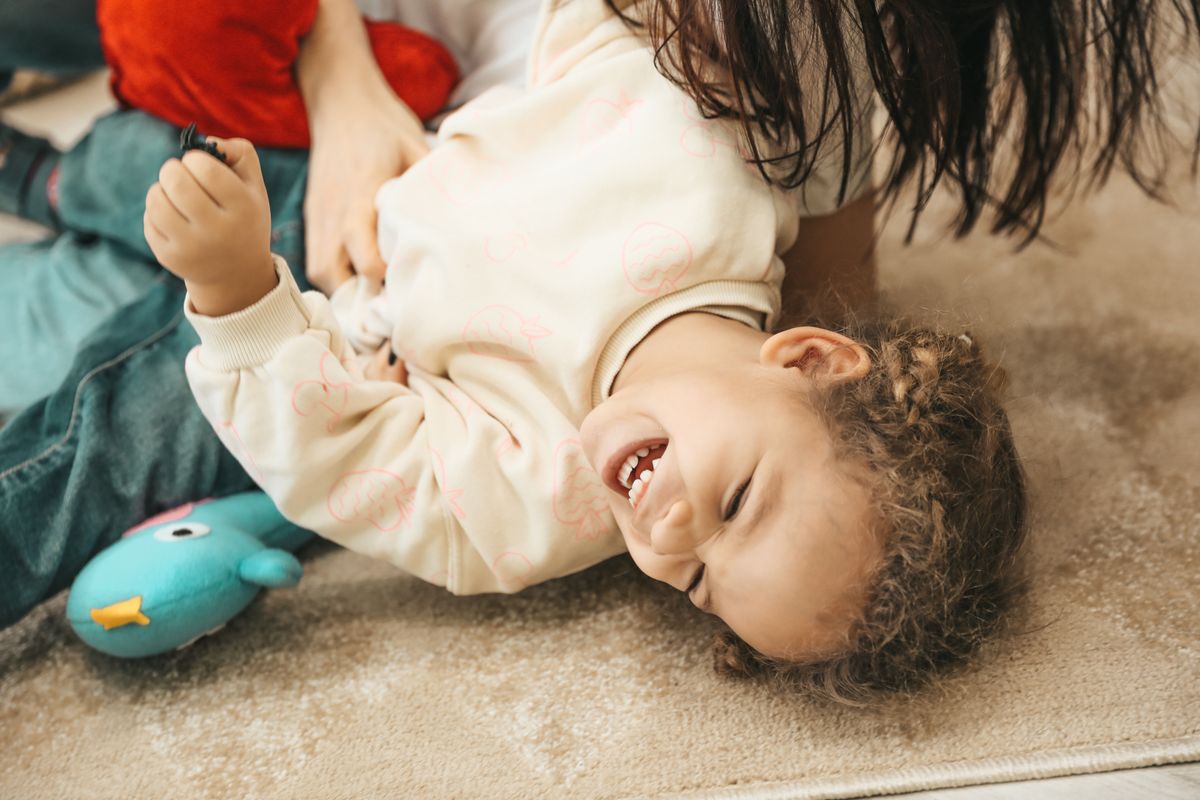 A parent and child sharing a warm, playful moment together